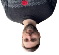 Yes, I'm upside down A beardy man in his late 30s, wearing a comfy jumper, upside down